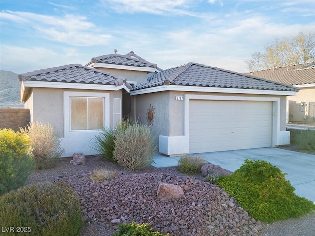 single story home with a garage and an outbuilding