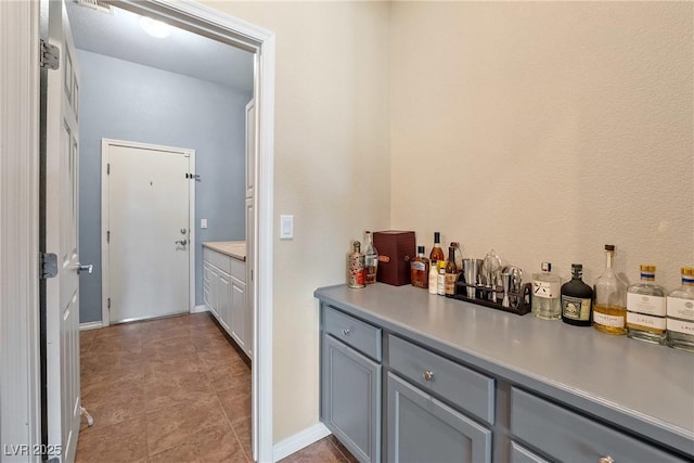 bar with gray cabinetry