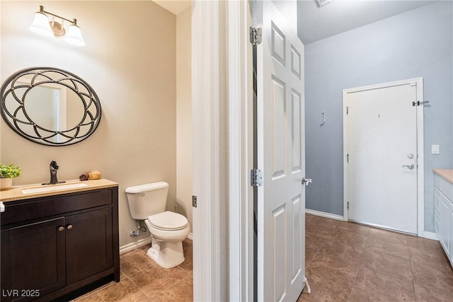 bathroom with vanity, tile patterned floors, and toilet