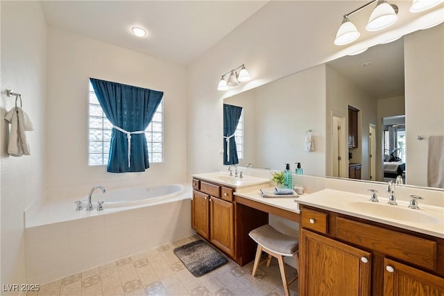 bathroom featuring vanity and tiled bath