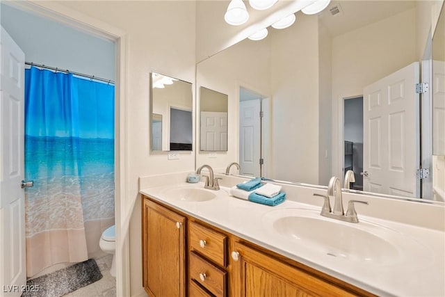 bathroom with vanity, tile patterned floors, and toilet