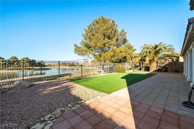 view of yard with a water view and a patio area