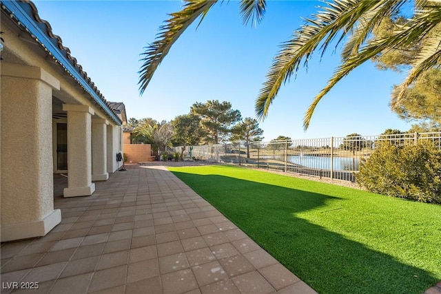 view of yard featuring a patio and a water view