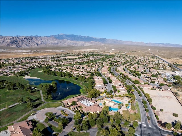 drone / aerial view with a water and mountain view