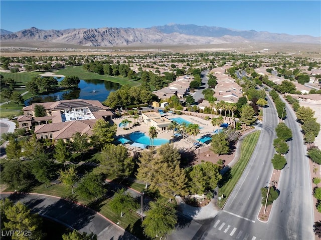 birds eye view of property with a water and mountain view