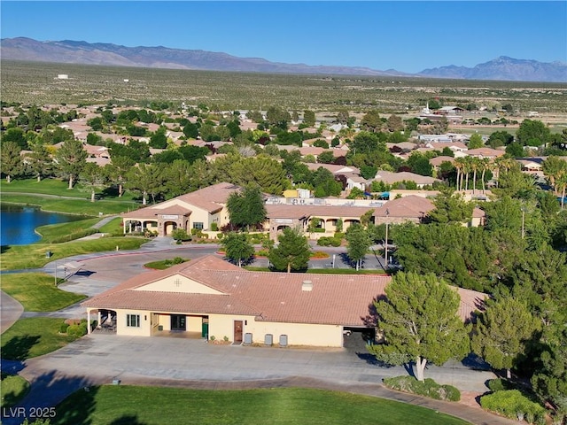 birds eye view of property with a water and mountain view