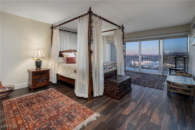 bedroom with access to exterior and dark hardwood / wood-style flooring