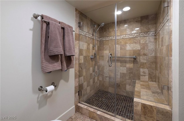 bathroom featuring a shower with shower door