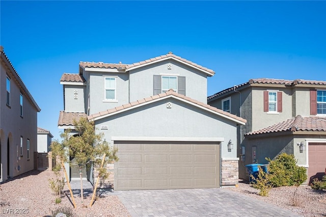 mediterranean / spanish-style house with a garage