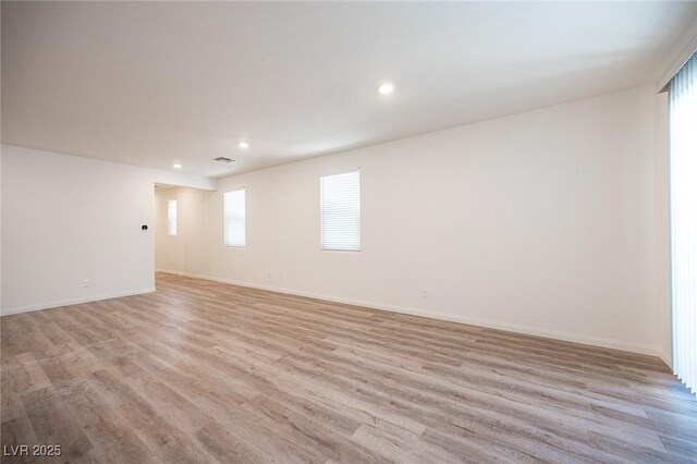 unfurnished room with light hardwood / wood-style floors