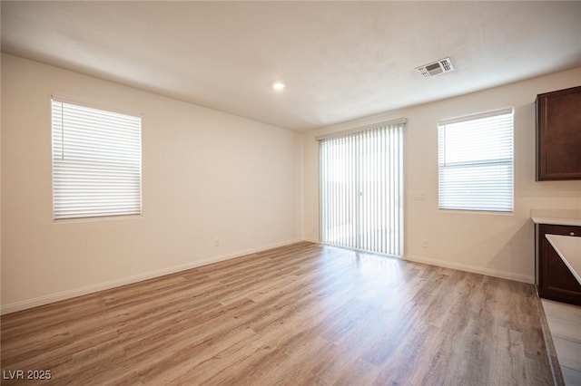 unfurnished room with light hardwood / wood-style flooring