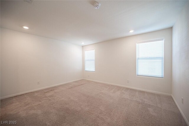 unfurnished room featuring light colored carpet