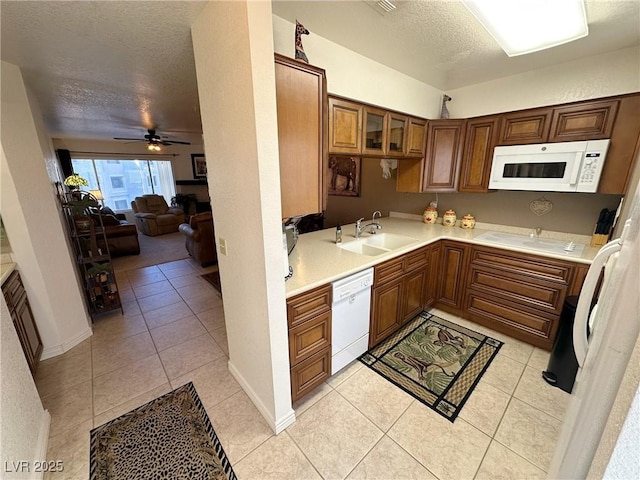 kitchen featuring white appliances, a textured ceiling, sink, ceiling fan, and light tile patterned floors