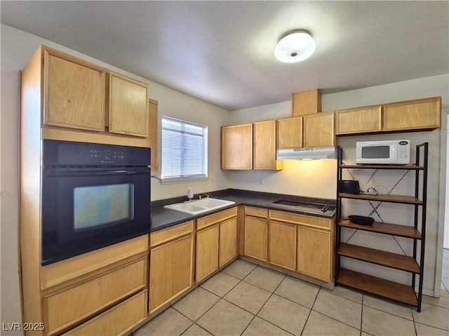 kitchen featuring black appliances, light brown cabinetry, light tile patterned floors, and sink