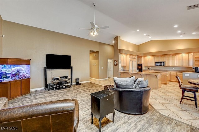 tiled living room featuring vaulted ceiling and ceiling fan