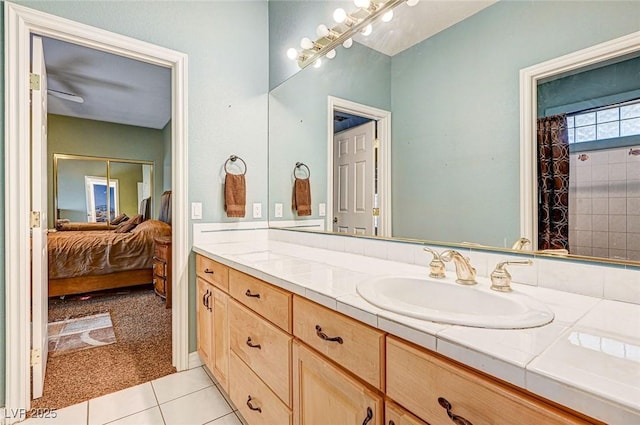 bathroom with tile patterned flooring, a shower with shower curtain, and vanity