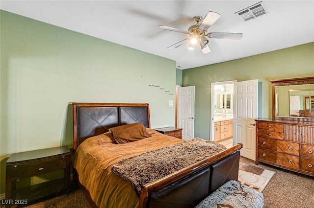 bedroom featuring ceiling fan, carpet flooring, and ensuite bath