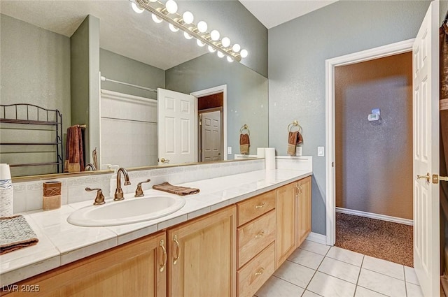 bathroom featuring tile patterned flooring and vanity