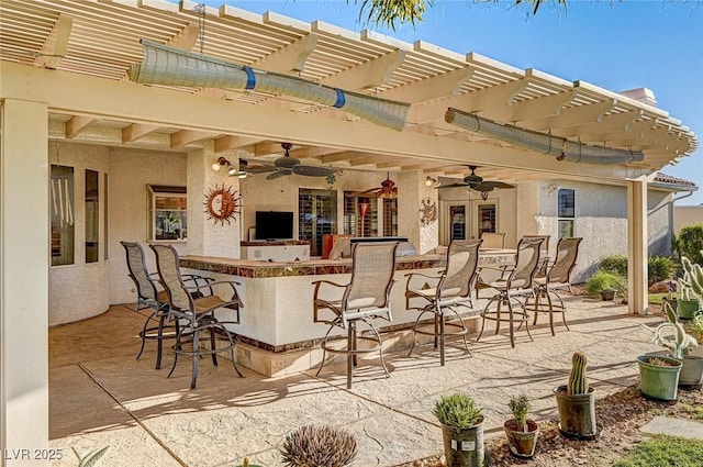 view of patio / terrace featuring exterior bar, a pergola, and ceiling fan