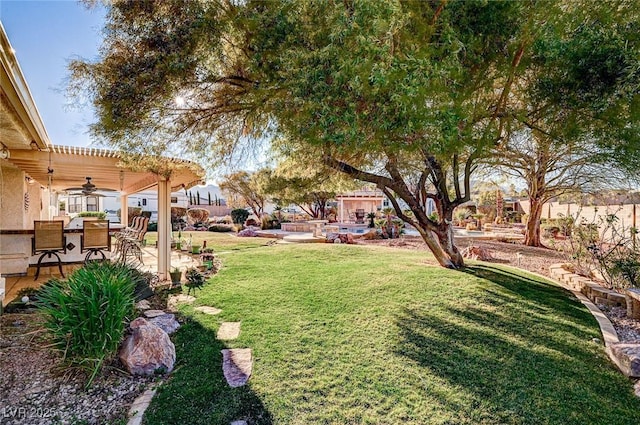 view of yard featuring a patio area, a pergola, and ceiling fan