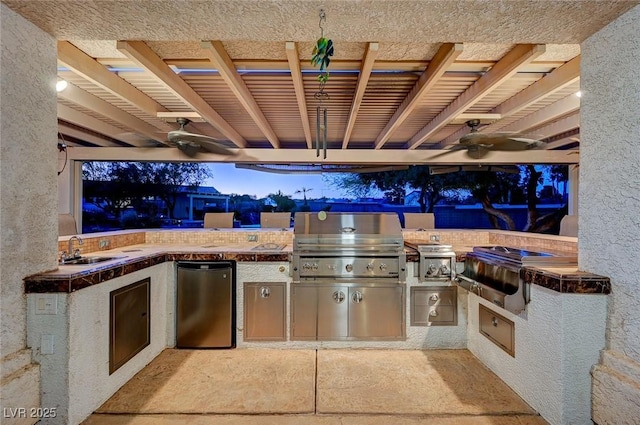 view of patio / terrace with area for grilling, sink, and ceiling fan