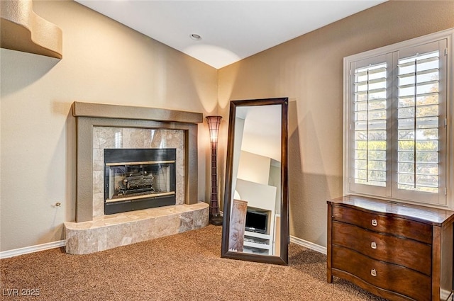 living room with carpet floors and a tiled fireplace