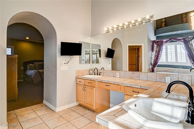 bathroom with tile patterned flooring and vanity