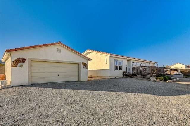 view of front facade with a garage and a deck