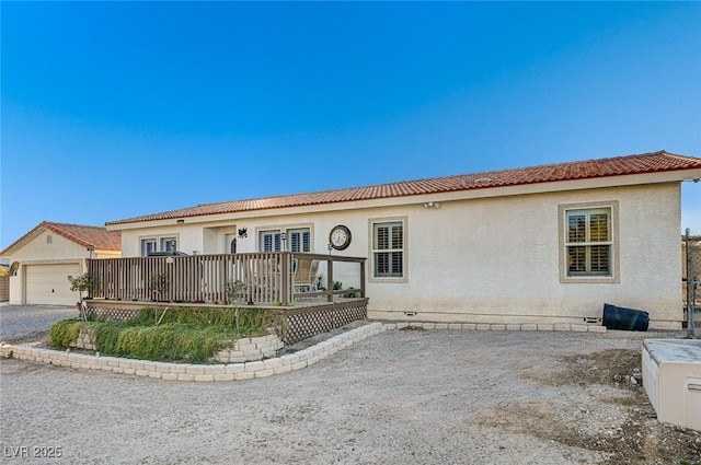 view of front of property with a wooden deck and a garage