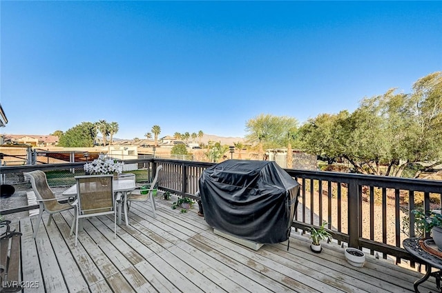 wooden terrace featuring grilling area