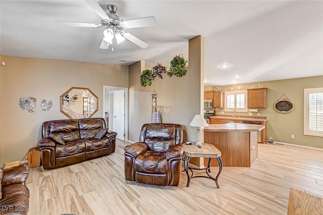 living room with sink and ceiling fan