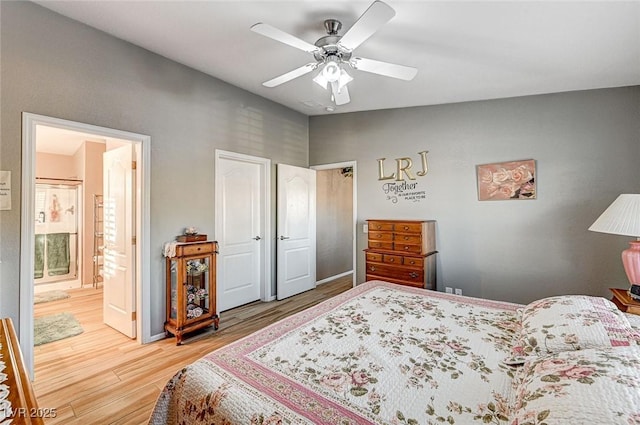 bedroom with ceiling fan, ensuite bathroom, and wood-type flooring