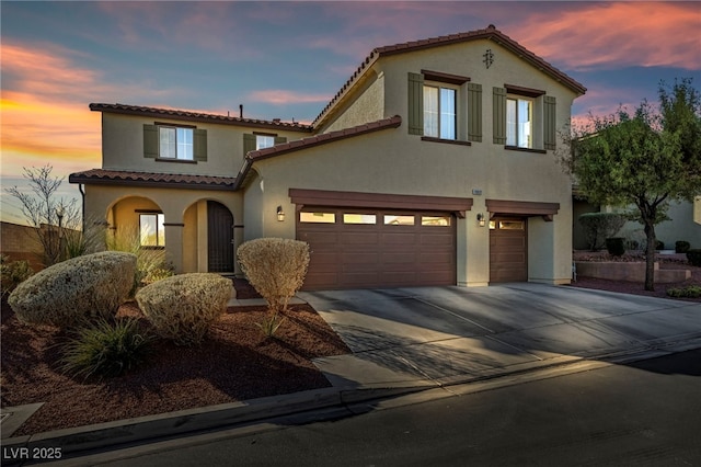 mediterranean / spanish-style house featuring a garage