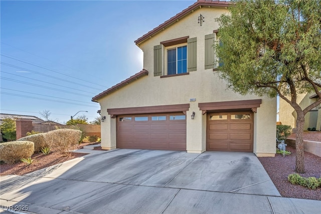 mediterranean / spanish-style home with a garage