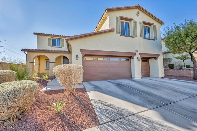 mediterranean / spanish-style house featuring a garage