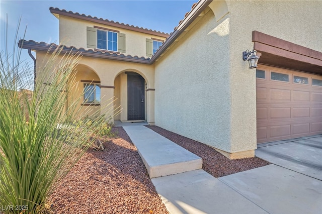 doorway to property with a garage