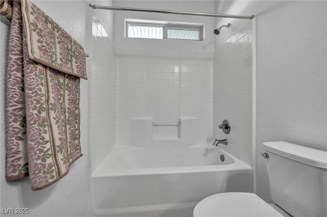 bathroom featuring bathing tub / shower combination and toilet