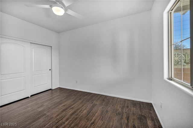 unfurnished bedroom featuring dark wood-type flooring, a closet, and ceiling fan