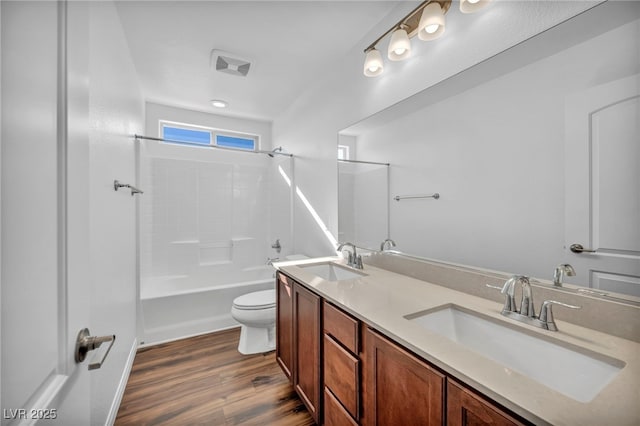 full bathroom with hardwood / wood-style floors, toilet, shower / bathing tub combination, and vanity