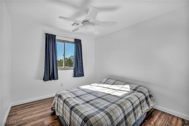 bedroom with ceiling fan and dark wood-type flooring