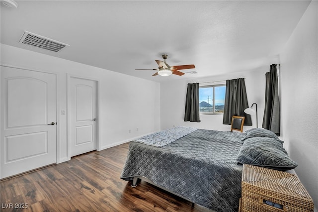 bedroom featuring dark wood-type flooring and ceiling fan