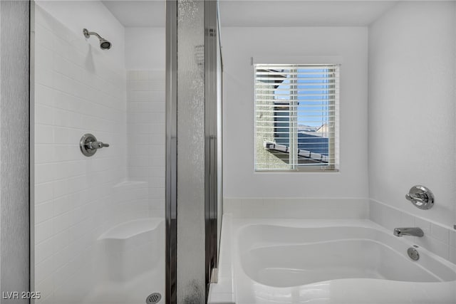 bathroom with shower with separate bathtub