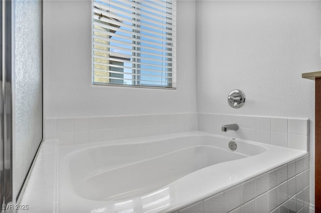 bathroom featuring tiled bath