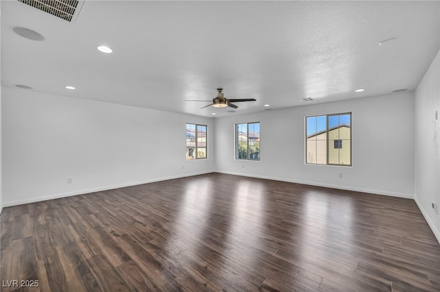 empty room featuring a textured ceiling, ceiling fan, and dark hardwood / wood-style flooring