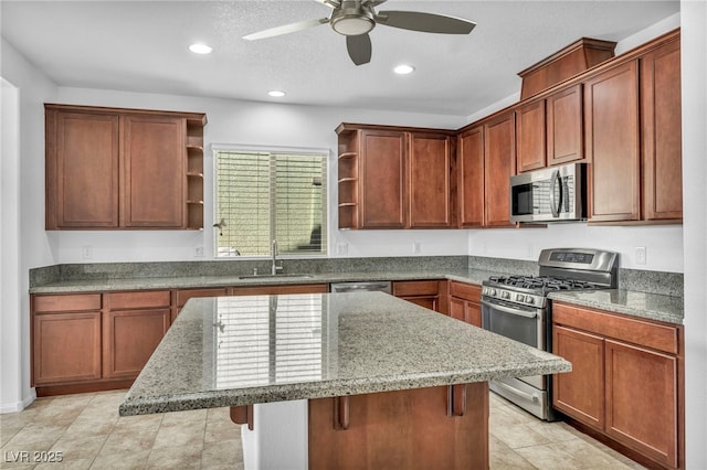 kitchen with stone counters, appliances with stainless steel finishes, sink, a kitchen island, and a breakfast bar