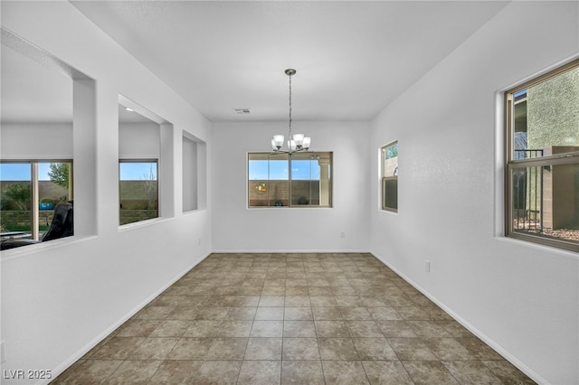 unfurnished dining area featuring an inviting chandelier