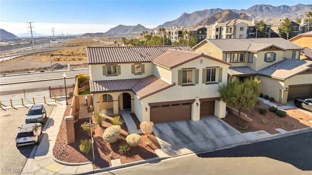 view of front facade featuring a mountain view and a garage