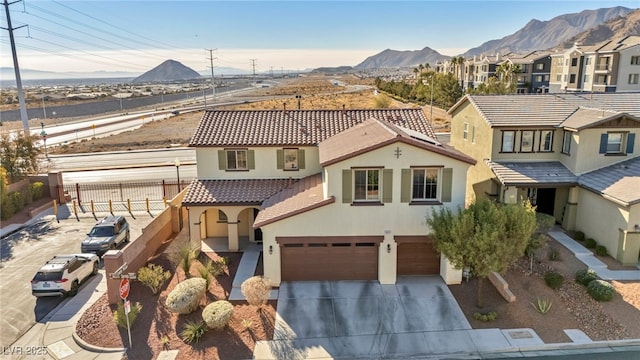 view of front of home featuring a mountain view and a garage