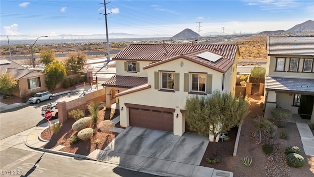 view of front of property featuring a mountain view and a garage