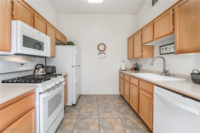 kitchen featuring sink, white appliances, light brown cabinets, and light tile patterned flooring